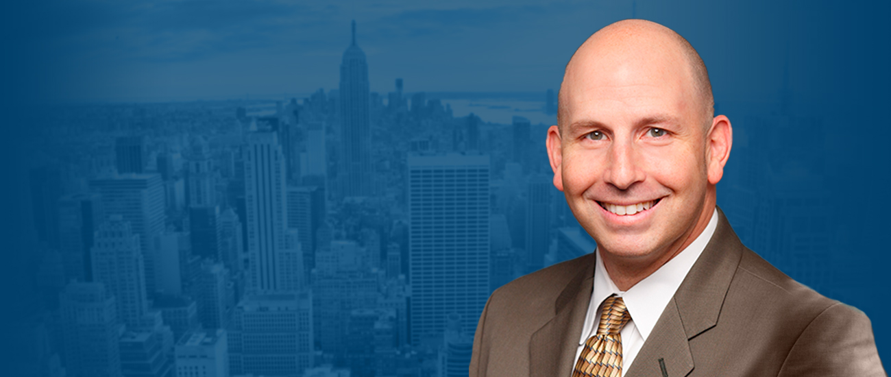 Richard K. Hellerman with the New York Skyline in the background